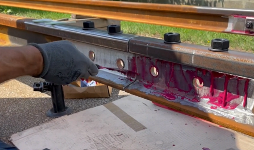 Adhesive applied to a railway joint component during the bonding process
